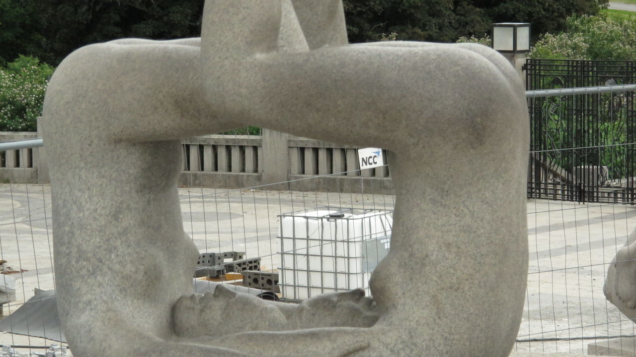 CLOSE-UP OF STATUE AGAINST METAL PARK