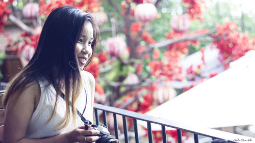 Portrait of smiling young woman looking away