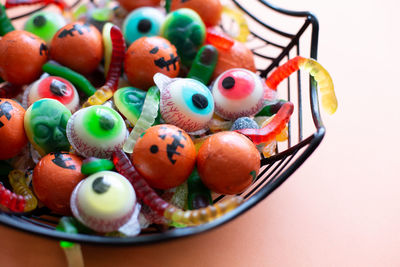 High angle view of multi colored candies in container on table