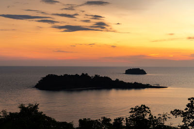 Scenic view of sea against orange sky