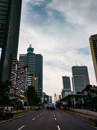 City street and modern buildings against sky