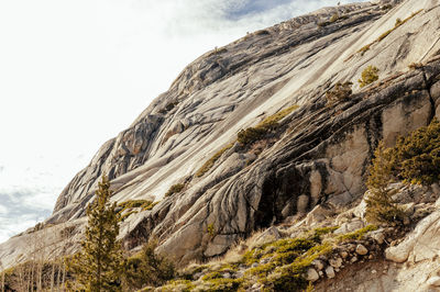 Low angle view of rock formation against sky