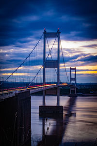 View of suspension bridge against cloudy sky