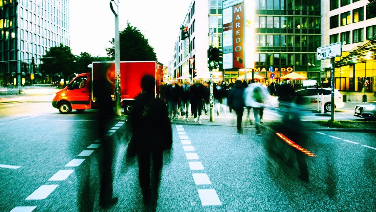 building exterior, street, city, architecture, transportation, built structure, city life, city street, car, land vehicle, men, road, mode of transport, walking, road marking, zebra crossing, person, the way forward, on the move