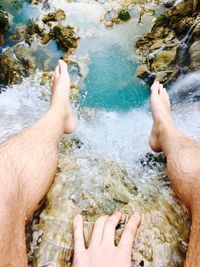 Low section of man feet in water