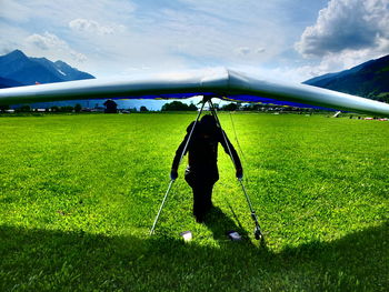 Full length of man on golf course on field against sky