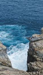 High angle view of rocks on sea shore