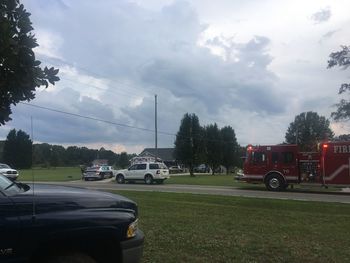 Cars on road against sky in city