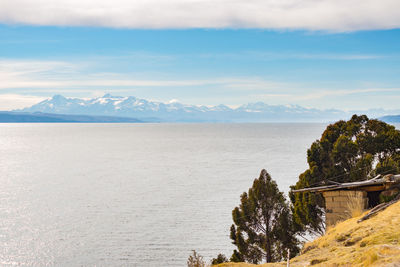 Scenic view of sea and mountains against sky