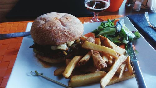 Close-up of burger and vegetables in plate