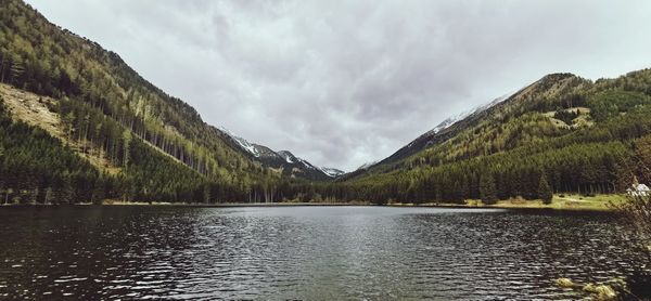 Scenic view of lake and mountains against sky