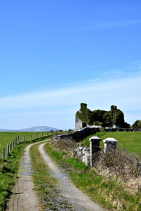 Walkway against clear blue sky