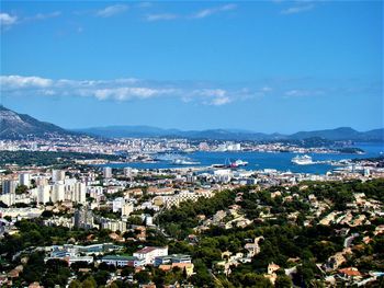 Scenic view of sea and mountains against blue sky