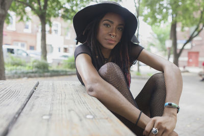 A young woman wearing a black hat.