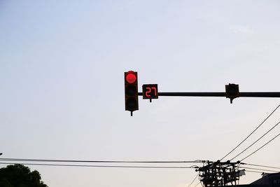 Low angle view of road signal against sky