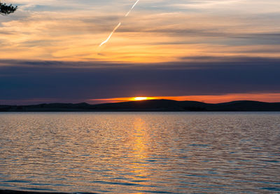 Scenic view of sea against orange sky