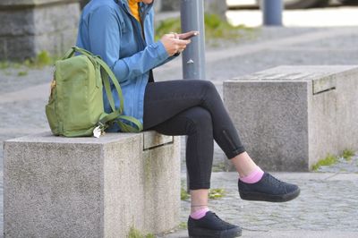 Side view of woman sitting on seat