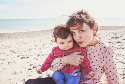 Portrait of mother and daughter at beach