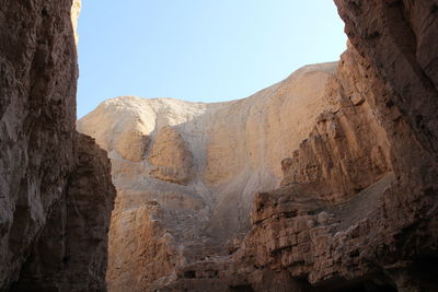 Low angle view of rocky mountains at wadi og