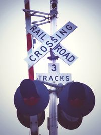 Low angle view of road sign against sky