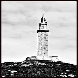 Lighthouse against cloudy sky