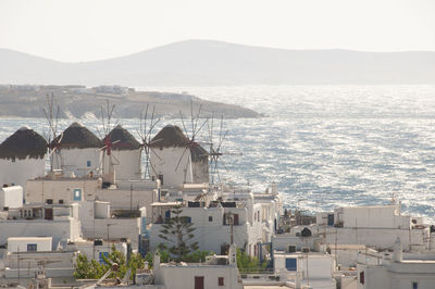 High angle view of townscape by sea against sky