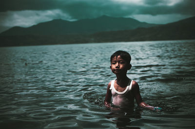 Portrait of boy swimming in sea