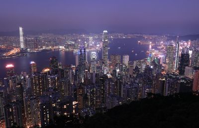 Aerial view of illuminated cityscape against sky at night