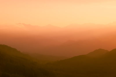 Scenic view of silhouette mountains against sky during sunset