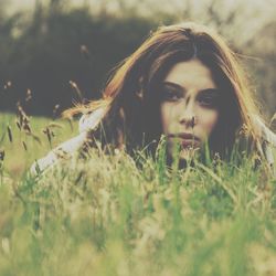 Portrait of woman standing on field