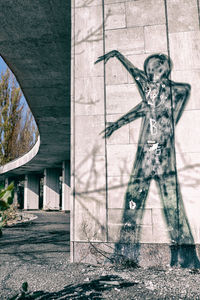 Shadow of statue on wall of building