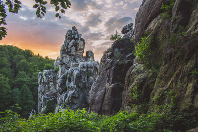 Low angle view of rock formations against sky