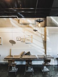 Empty chairs and table in illuminated room