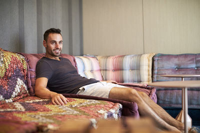 A man relaxes on a comfortable modern couch.