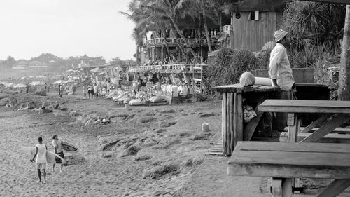 Rear view of people walking on land