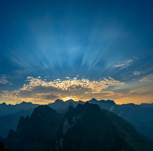 Scenic view of silhouette mountains against sky at sunset