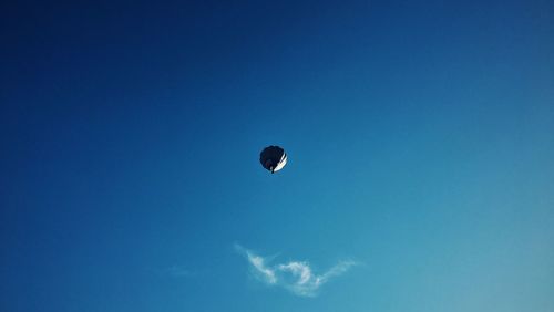 Low angle view of hot air balloon against blue sky