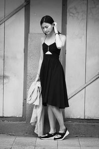 Woman standing against wall