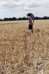 Man standing on field against sky