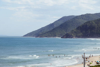 Scenic view of sea and mountains against sky