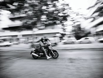 Blurred motion of man riding motorcycle