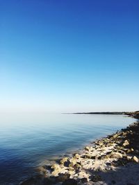 Scenic view of sea against clear blue sky