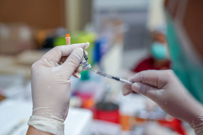 Doctor filling syringe with covid-19 vaccine doctor or scientist in the covid-19 medical vaccine 