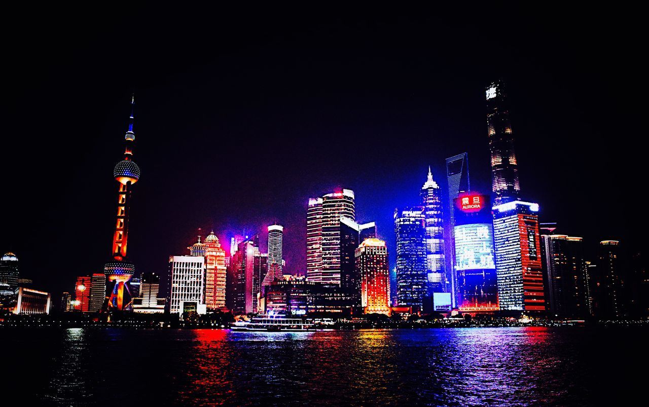 ILLUMINATED BUILDINGS AT WATERFRONT