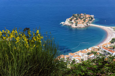 High angle view of sea and buildings in city