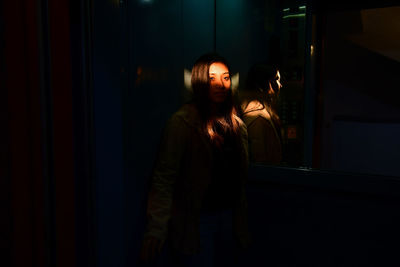 Young woman looking away at home