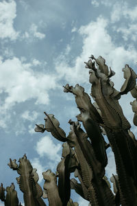 Low angle view of angel statue against sky