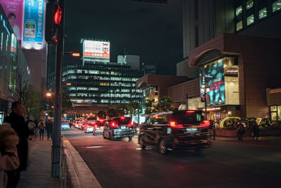 People on city street at night