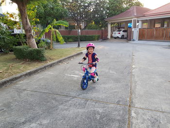 High angle view of people riding motorcycle on road
