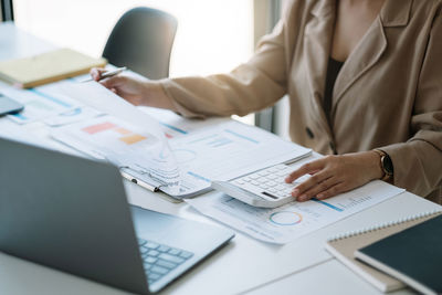 Midsection of business people working at office